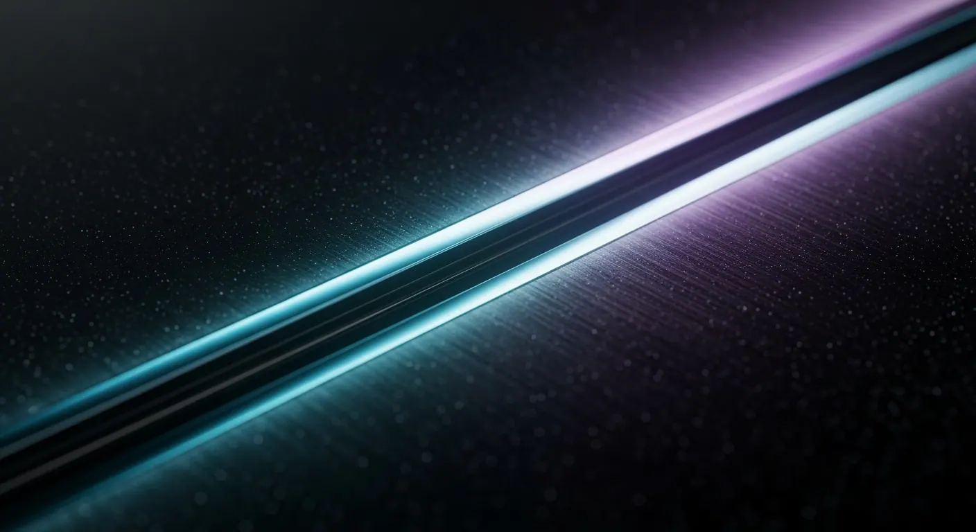 Polished chrome Silverstone emblem catching cyan and violet light in darkness.